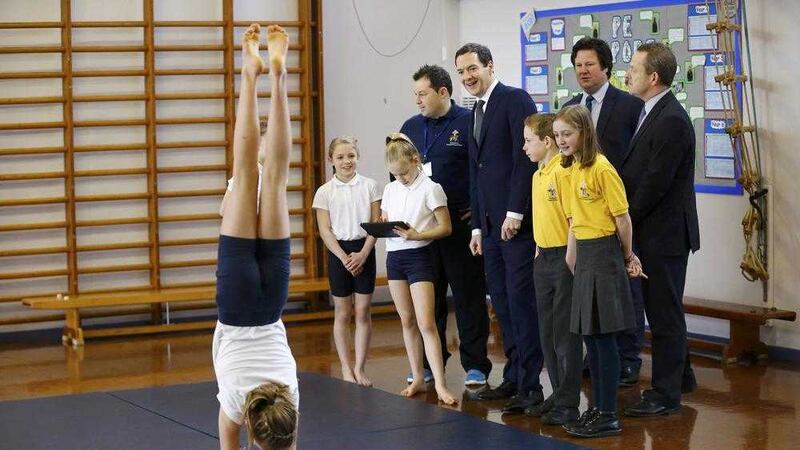 Chancellor of the Exchequer George Osborne speaks to pupils during a gymnastics lesson at St Benedict&#39;s Catholic Primary School in Garforth, West Yorkshire yesterday, the day after he delivered his Budget statement 