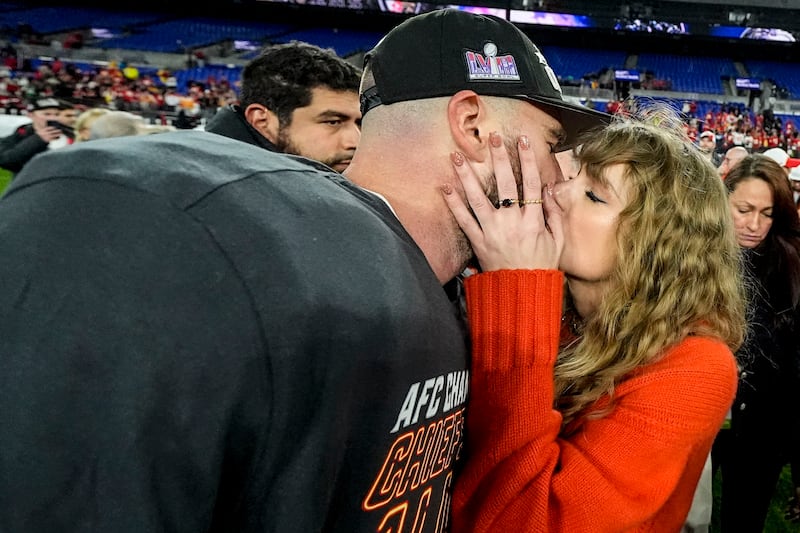 Taylor Swift kisses Kansas City Chiefs tight end Travis Kelce after an AFC Championship NFL football game against the Baltimore Ravens (Julio Cortez/AP)