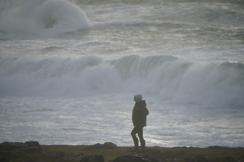 A tourist from Canada, on the Burren, near Black Head lighthouse, County Clare in the Republic of Ireland as Storm Jocelyn hits
