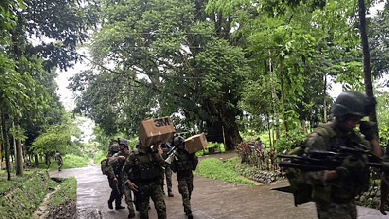 Philippine troops arrive at their barracks to reinforce fellow troops following the siege by Muslim militants on the outskirts of Marawi city in the southern Philippines on Wednesday PICTURE: AP 