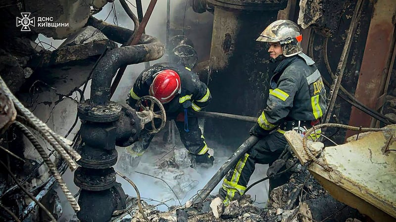 Emergency workers extinguish a fire after a Russian attack on the Trypilska thermal power plant in Ukrainka, Kyiv region (Ukrainian Emergency Service/AP)