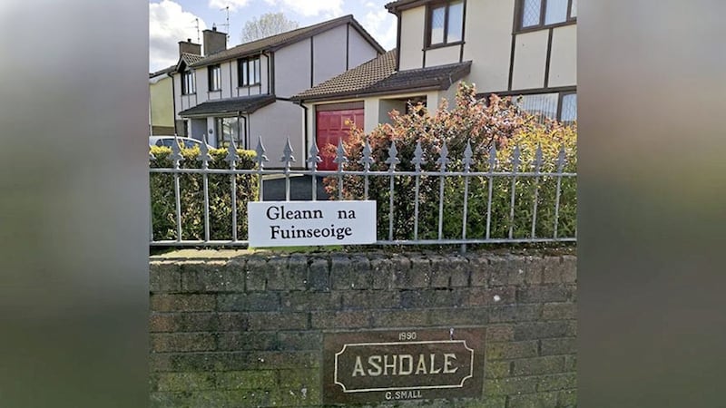 A council has threatened to prosecute an 85-year-old woman over an &quot;unauthorised&quot; Irish language street sign 