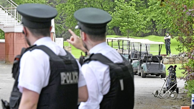 Police and army bomb disposal experts pictured dealing with the object believed to have been attached underneath a car that had been driven into Shandon Park Golf Club in east Belfast
