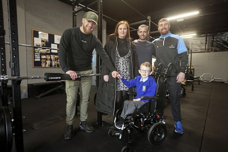 Eli Hicks with his parents Louise and Brian and Mark Rainey and Sam Carson from The Unit Gym in west Belfast. Picture by Mal McCann 