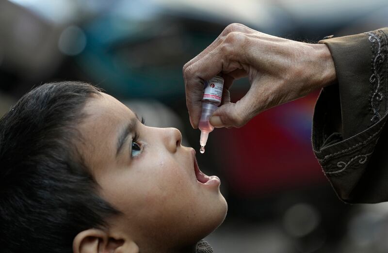 A health worker administers a polio vaccine to a child in Karachi (AP)