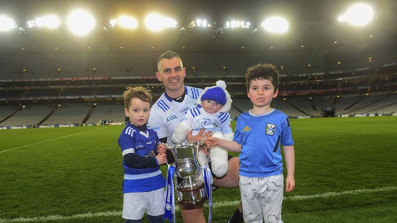 Raymond Galligan enjoys last Saturday's Division Three final triumph with baby son Rian and nephews Oisin Flanagan (right) and Jack Flanagan. Picture by Mark Marlow