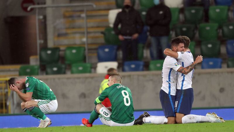 Northern Ireland players dejected as Slovakia celebrate winning the Path B play-off Final to reach the Euros.&nbsp;