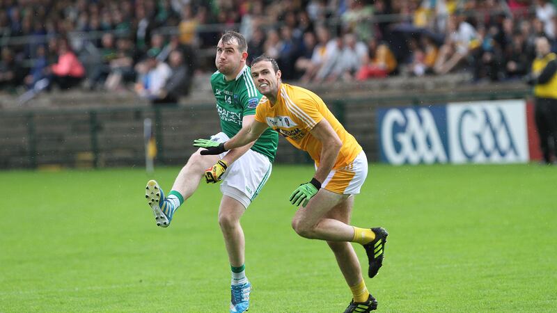 Antrim's Richard Johnson can only look on as Fermanagh's Se&aacute;n Quigley fires over the bar at Brewster Park on Sunday<br />Picture: Colm O'Reilly&nbsp;