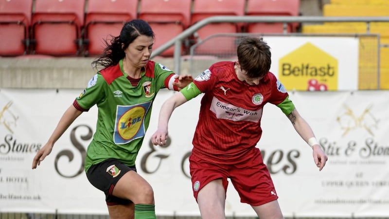 Glentoran Women&#39;s captain Jess Foy challenges Kirsty McGuinness of Cliftonville Ladies at Solitude. 