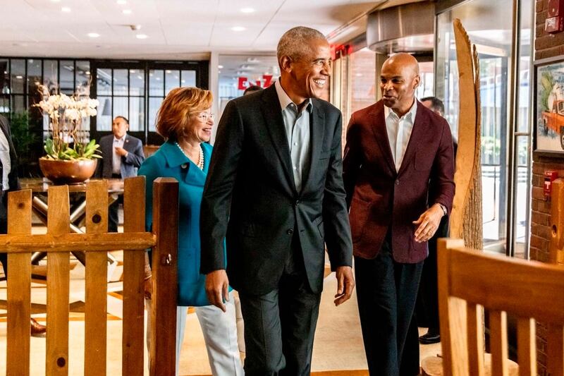 Former president Barack Obama with Valerie Jarrett, left, and Harvard basketball coach Tommy Amaker on their way into The Breakfast Club in Cambridge, Massachusetts