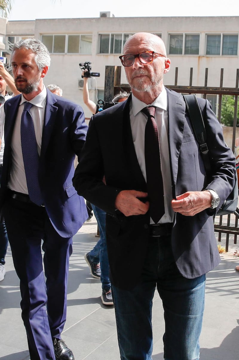 Canadian-born film director Paul Haggis, right, arrives with his lawyer Federico Straziota at Brindisi law court in southern Italy