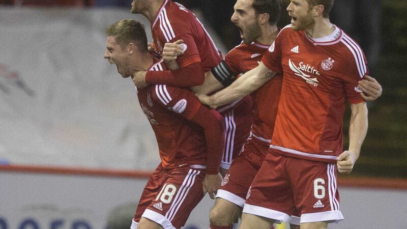 Aberdeen Simon Church (left) celebrates scoring his side's second goal during the Ladbrokes Scottish Premiership match at Pittodrie<br />Picture by PA