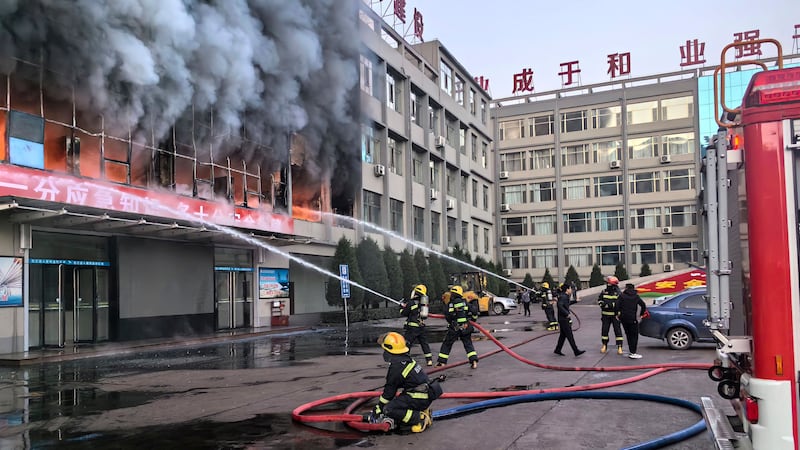 Firefighters tackle the blaze at a building of the the Yongju Coal Company in Lyuliang city (Xinhua/AP)