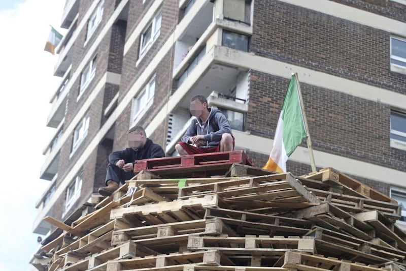 Two youths on top of a bonfire in the New Lodge, north Belfast 