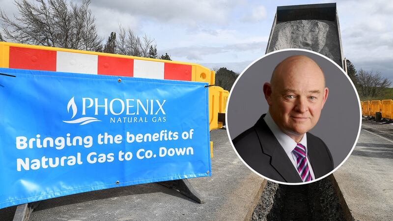 Signage at a Phoenix Energy work site, where pipeline is being installed in Co Down, with an inset image of Peter Dixon.