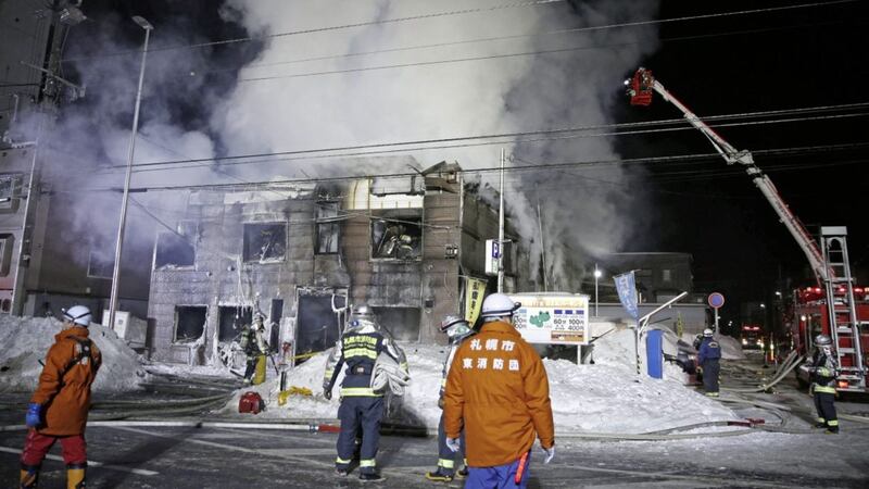 Firefighters work at the scene of a fire in Sapporo, northern Japan, early Thursday PICTURE: Yuya Shino/Kyodo News via AP 