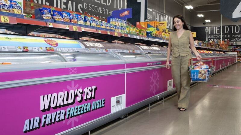 A customer looking at products on the ‘air fryer aisle’ at the Food Warehouse (Rachel Adams/PA)