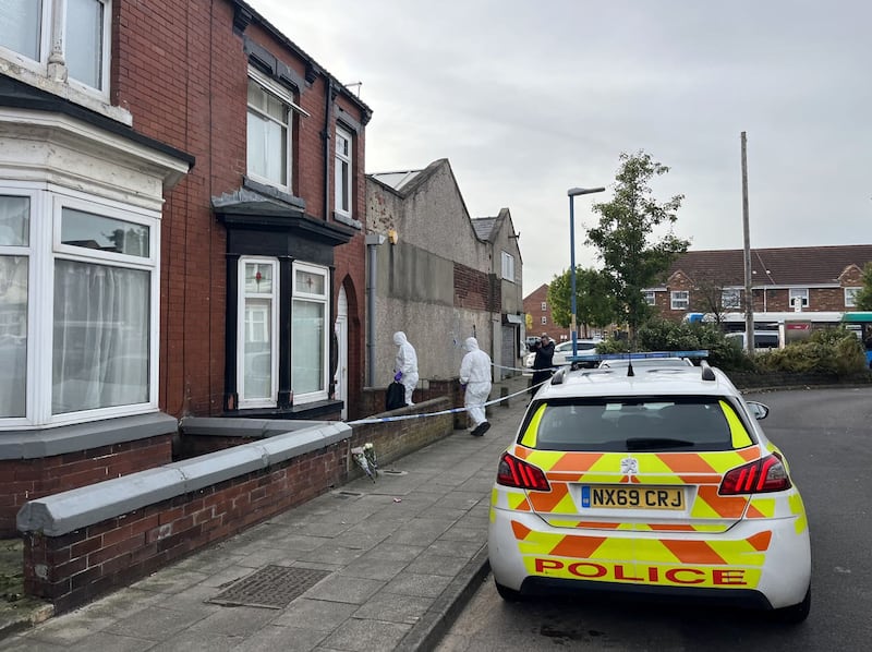 Two forensics officers enter a cordoned off property in Wharton Terrace, Hartlepool
