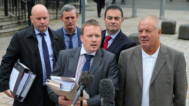Solicitor Ciaran O'Hare and Raymond McCord speak to the media outside Belfast High Court on Friday