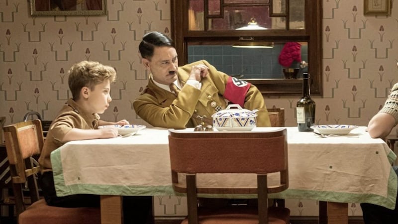 Roman Griffin Davis as Jojo Betzler, Taiki Waititi as Adolf Hitler and Scarlett Johansson as Rosie Betzler in Jojo Rabbit 