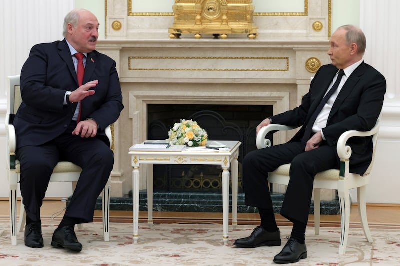 Russian President Vladimir Putin, right, listens to Belarus President Alexander Lukashenko during their meeting at the Kremlin in Moscow (Gavriil Grigorov/AP)
