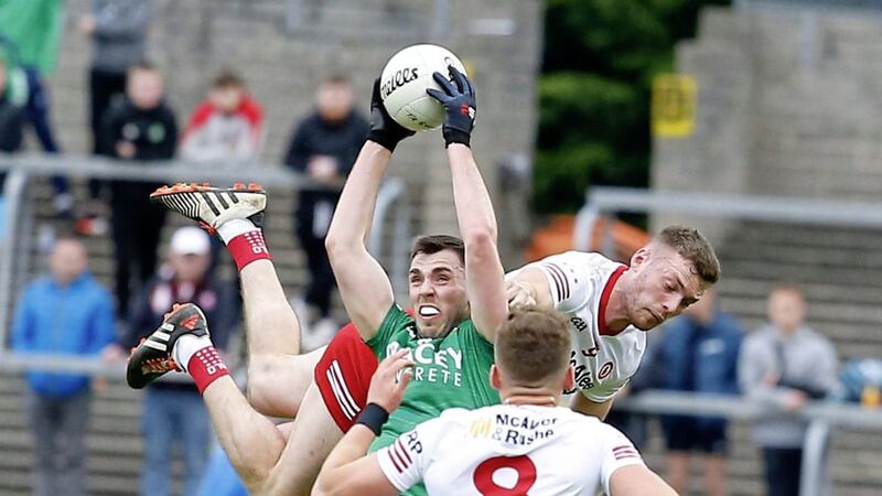 Fermanagh's Ryan Jones takes a catch under pressure from Tyrone midfield duo Brian Kennedy and Conn Kilpatrick (8) in the Ulster SFC preliminary round. <br />Pic Philip Walsh