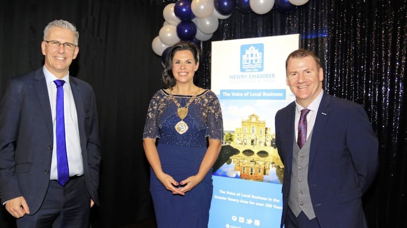Newry Chamber of Commerce president Emma Mullen-Marmion pictured at her banquet to mark the organisation&#39;s 200th anniversary, watched by BBC reporter Mark Simpson (left), who compered the event, and Chamber chief executive Tony McKeown 