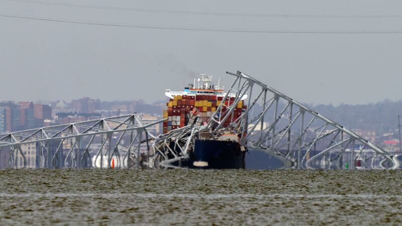 A container ship rests against wreckage of the Francis Scott Key Bridge (Mark Schiefelbein/AP)