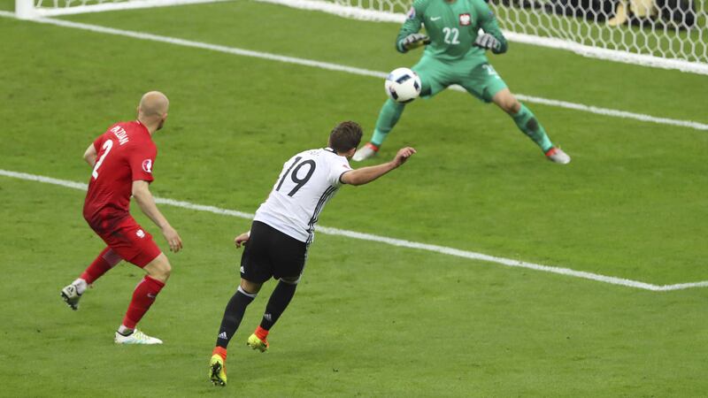 Germany's Mario Goetze, center, shoots on the goal of Poland goalkeeper Lukasz Fabianski. Picture by&nbsp;Thibault Camus, PA