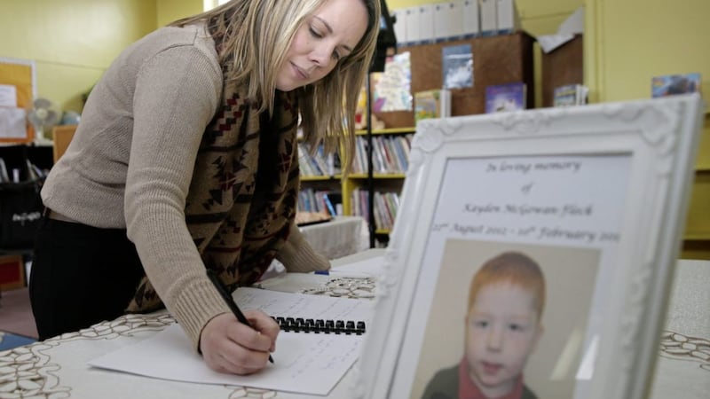 P1 teacher Sarah McCullough signing a book of condolence for five-year-old Kayden Fleck 