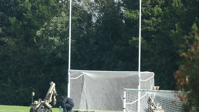 A bomb disposal officer examines a suspicious object left at playing fields used by East Belfast GAA. Picture by Mal McCann
