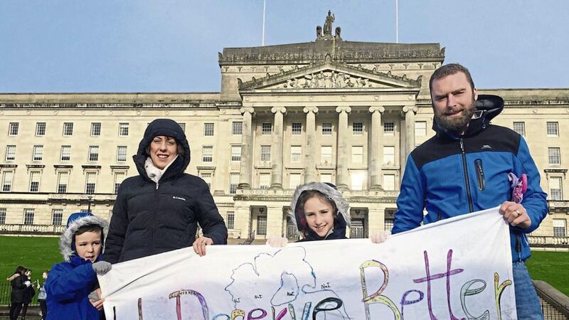 From left, Joseph, Emma, Abigail and Andrew Goudie from Rasharkin, Co Antrim, at the #Back2Work protest, outside Stormont. Picture by David Young/PA 
