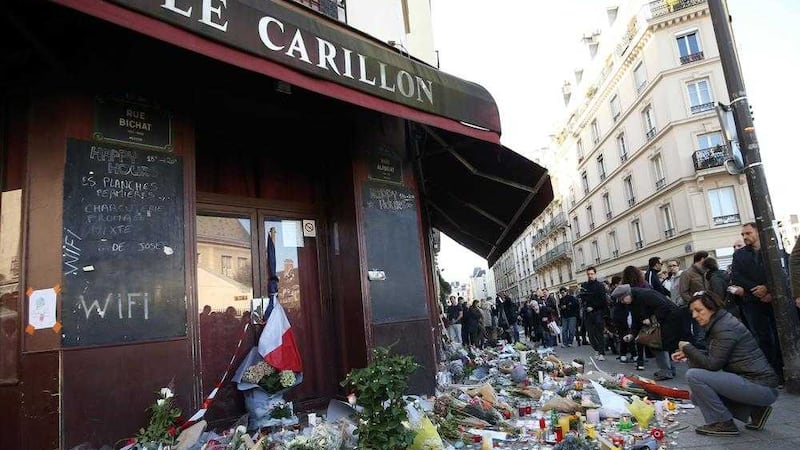 Tributes are left at the La Carillon restaurant in Paris, following the attacks in the French capital. Picture by Steve Parsons, PA Wire