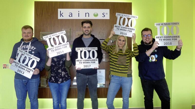 Kainos staff show off their five Sunday Times awards 