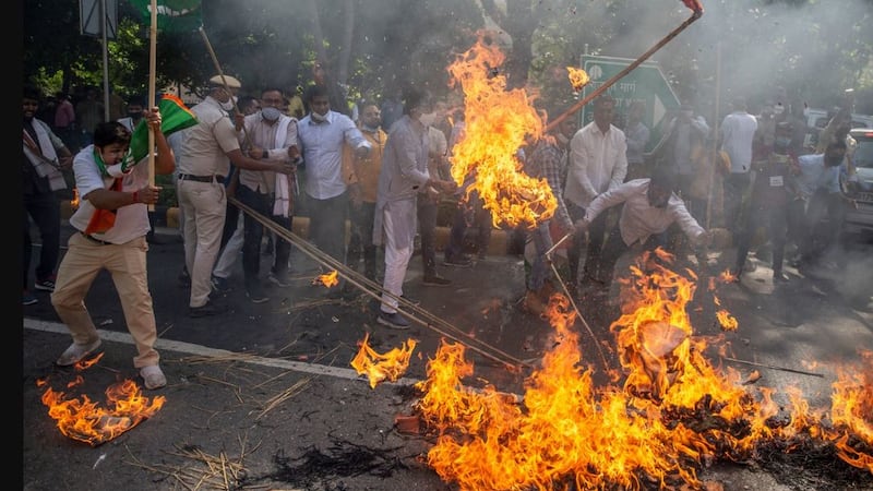 &nbsp;Supporters of India's opposition Congress party beat a burning effigy of Uttar Pradesh state chief minister Yogi Adityanath during a protest against the gang rape and killing of a woman in New Delhi, India, on September&nbsp;30 2020. Picture by&nbsp;Altaf Qadri, AP