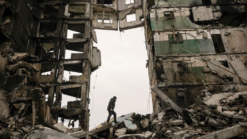A resident looks for belongings in an apartment building destroyed during fighting between Ukrainian and Russian forces in Borodyanka, Ukraine (Vadim Ghirda/AP)