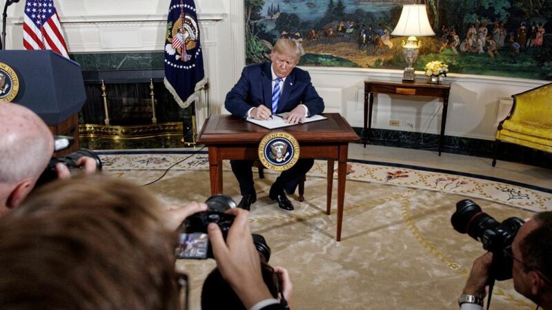 US president Donald Trump signs a Presidential Memorandum on the Iran nuclear deal from the Diplomatic Reception Room of the White House, on Tuesday, May 8. Picture by Evan Vucci, Associated Press 