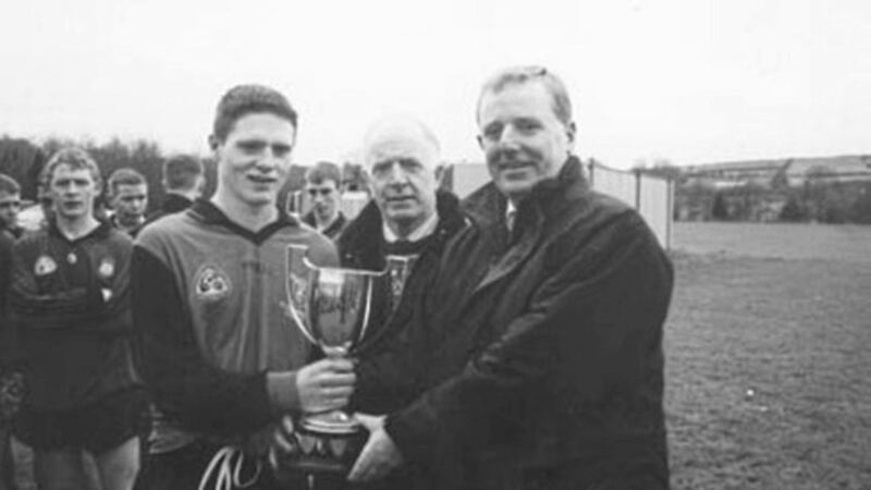 MARK OF CHAMPIONS... St Columban&rsquo;s captain Mark Doran (left) receives the Down U16 trophy from Declan Moore (Ulster Bank), as South Down GAA chairman Gerry Quinn (RIP) looks on. The Kilkeel side defeated St Mark&rsquo;s Warenpoint in the final 