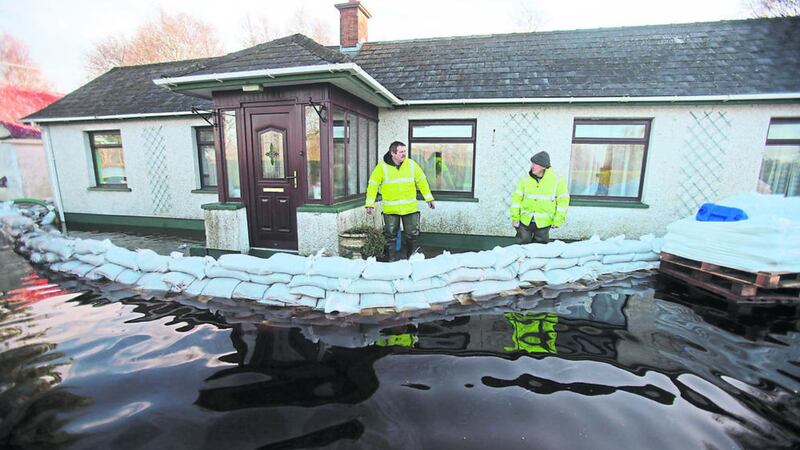 A Rivers Agency staff member talks to Jimmy Quinn from Derrytresk, near Dungannon, who was among those affected by the rising water levels in Lough Neagh in January. Picture by Niall Carson/PA Wire