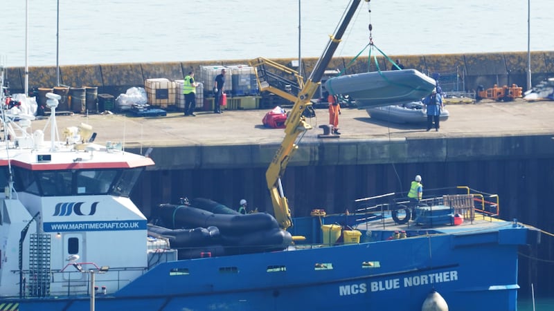 Boats used by people thought to be migrants are lifted on to the quayside in Dover, Kent