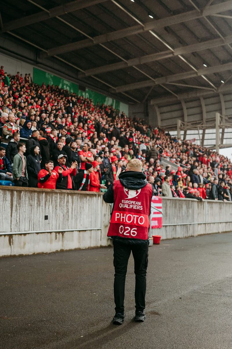 Blair McNally capturing footage of the Cliftonville fans at Windsor Park during the Irish Cup final
