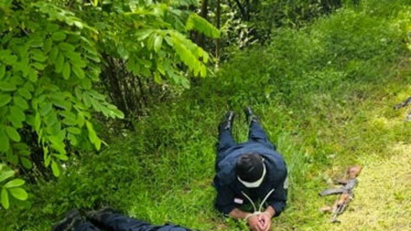 Three Kosovo police officers captured by Serbian police officers lie face down on a field (Serbian Ministry of Interior via AP/PA)