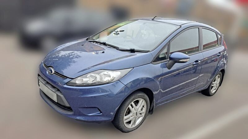 A blue Ford Fiesta believed to be the getaway car used by the New IRA after John Caldwell was shot last week 