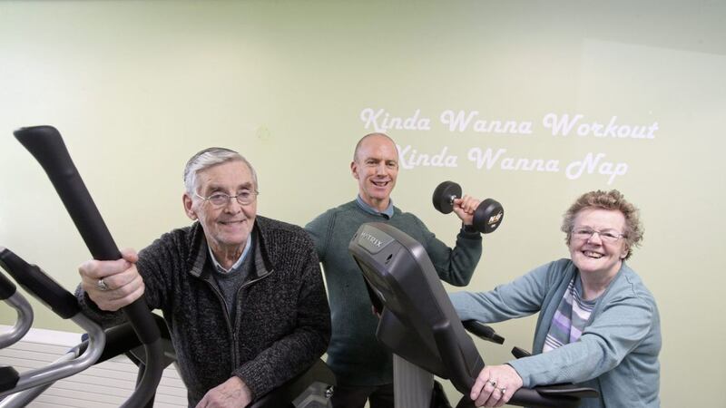 Joe Gillen (81) and Marie Smyth (74) try out some the gym equipment with Micky McGurran at the new Cupar Street Youth Club for Older People in west Belfast. Picture by Mal McCann 