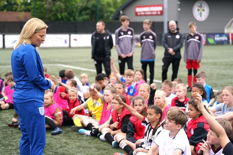 England manager Sarina Wiegman speaks to children at Boldmere St Michaels FC (Jacob KIng/PA)