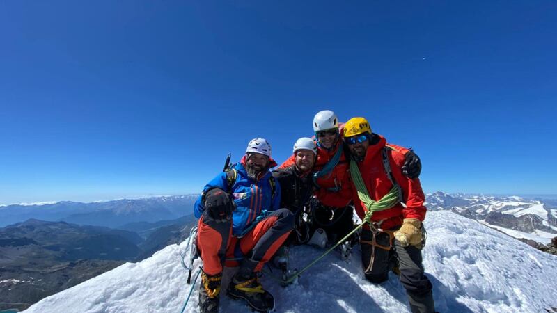 Former soldier Neil Heritage has become the first above-the-knee double amputee to summit the Alpine mountain.