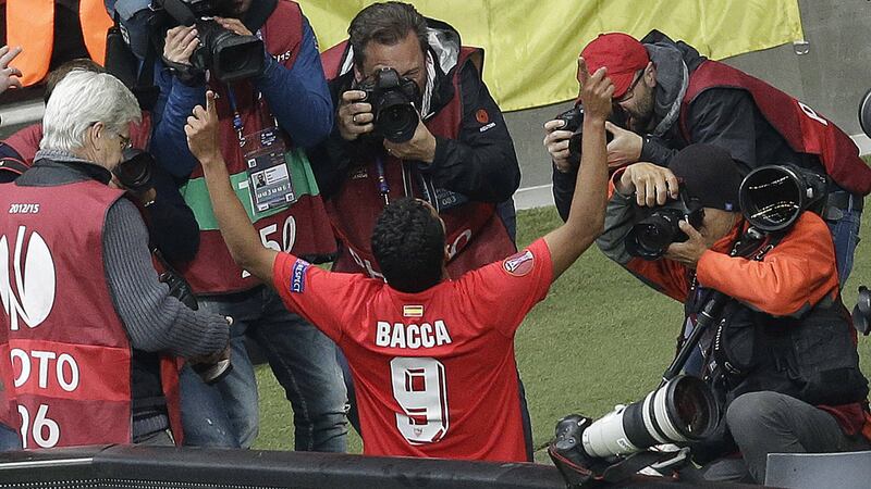 Photographers surround Sevilla striker Carlos Bacca after he scored in the Europa League final win over FC Dnipro 