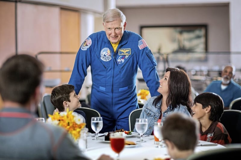 Jon McBride talks to a family at the Dine With An Astronaut lunch at Kennedy Space Center, Florida 