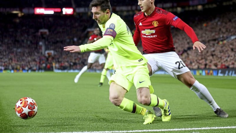Manchester United&#39;s Diogo Dalot (right) and Barcelona&#39;s Lionel Messi battle for the ball during the UEFA Champions League quarter final, first leg match at Old Trafford. 
