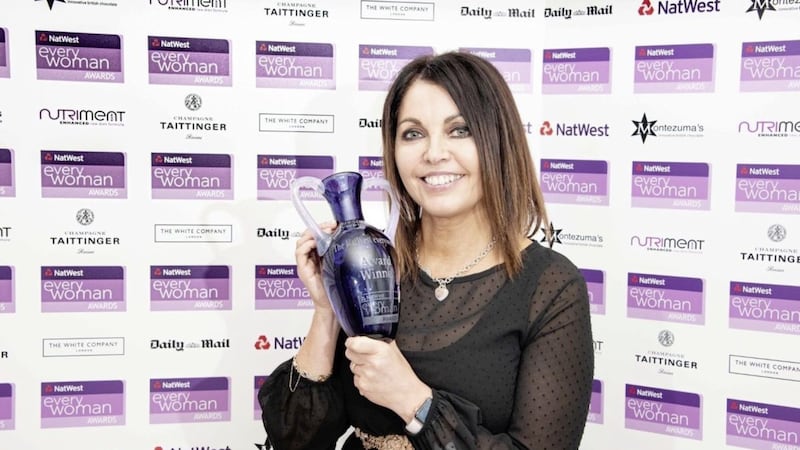 Mairead Mackle shows off the NatWest EveryWoman Woman of the Year Award after a ceremony in London 